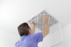 Person,removing,ceiling,air,filter.,caucasian,male,removing,a,square